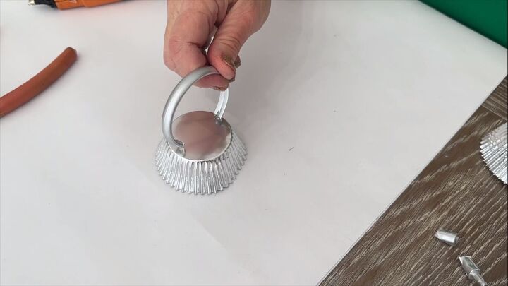 Gluing the shower curtain ring to the cupcake liner