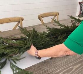 Placing a Christmas tree garland on a paper table runner