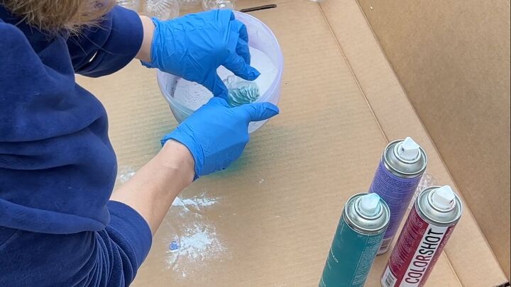 Dipping the painted ornaments in the flour and baking soda mixture