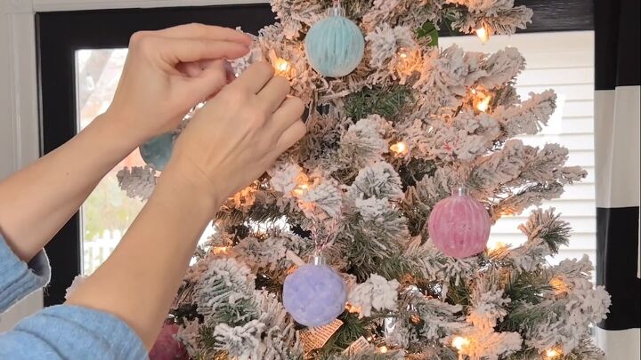 Hanging DIY flocked ornaments on a Christmas tree