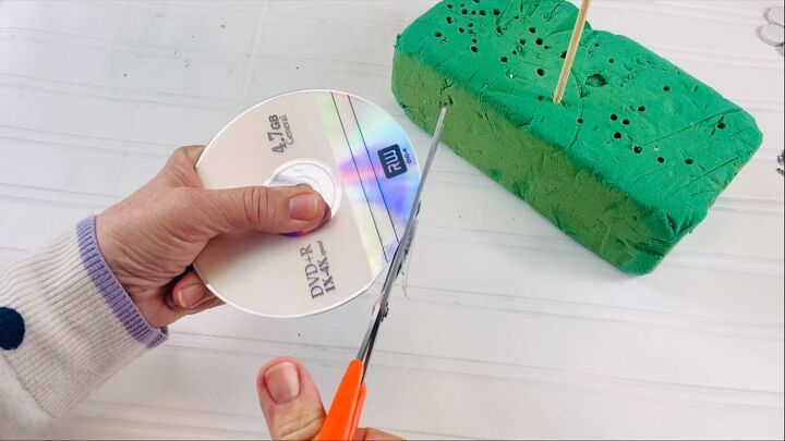 Cutting around the rim of the DVD