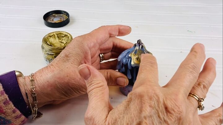Applying gold wax with fingertips