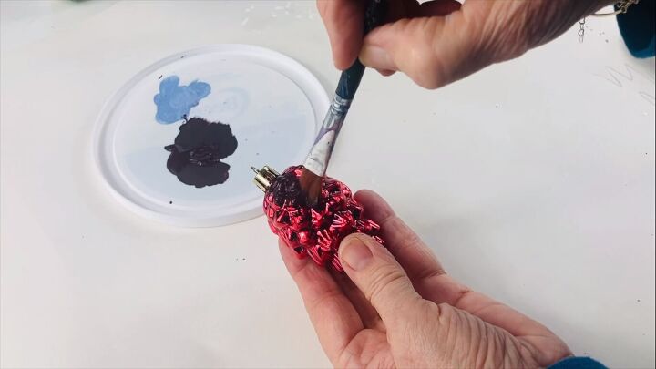 Painting the top of the pine cone ornament