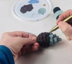 Adding gold dots on the points of the pine cone