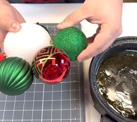 Gluing ornaments to the styrofoam ball