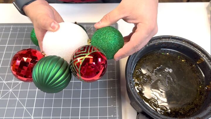 Gluing ornaments to the styrofoam ball