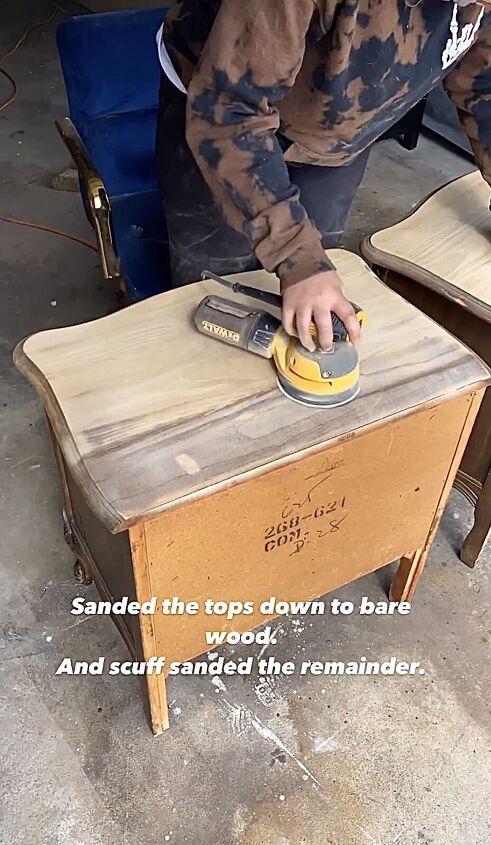 Sanding the tops of the nightstands with an electric sander