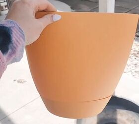 She flips over a planter and places it on her porch for this lovely curb appeal boost