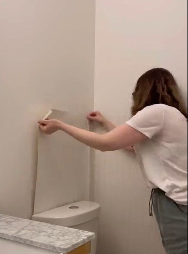 Applying wallpaper to the wall