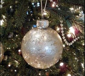 Mercury glass ornament hanging on a tree
