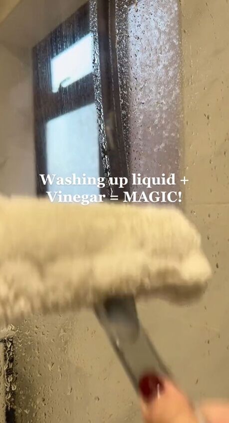 Using a squeegee to wipe down the glass