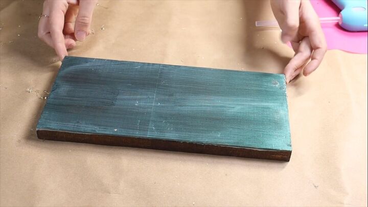 Wood block with an iridescent green painted top coat