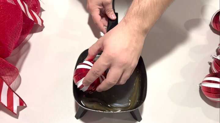 Dipping the ornament in a hot glue skillet