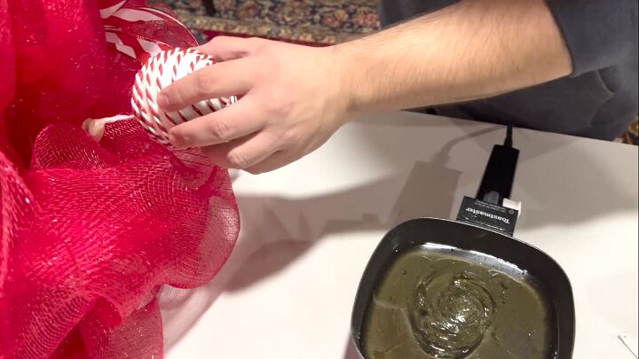 Hot gluing the ornaments to the tree