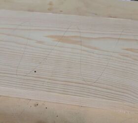 Lightly pencil over the board before sanding