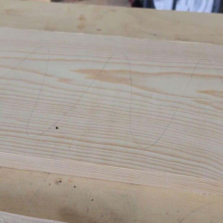 Lightly pencil over the board before sanding