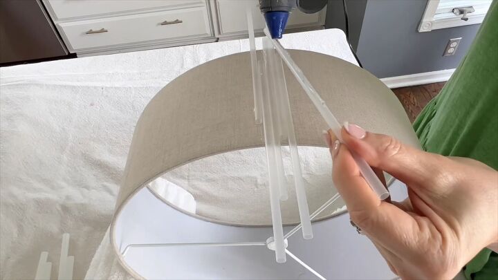 lampshade makeover crafting with straws, Use hot glue to attach the straws to the drum shade