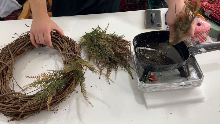 Dip branches into the glue skillet and stick them in the wreath