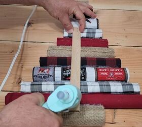 Gluing a paint stir stick to the back of the Christmas tree