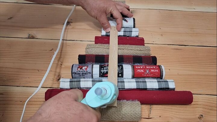 Gluing a paint stir stick to the back of the Christmas tree