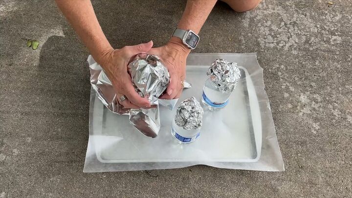 Cover the water bottle and foil head with another piece of foil