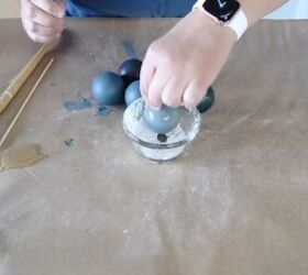Add clear glue to the bauble and roll it in baking soda