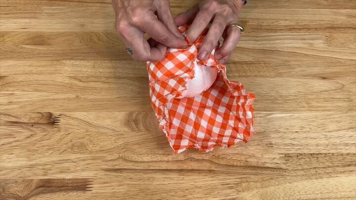 Fabric being wrapped around the foam pumpkin