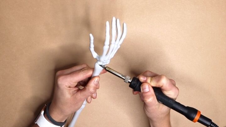 Use a wood burning tool to melt the wrist area