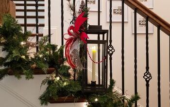 Decorating The Stairs With Christmas Garland And Lanterns
