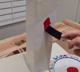 Applying red paint to the post