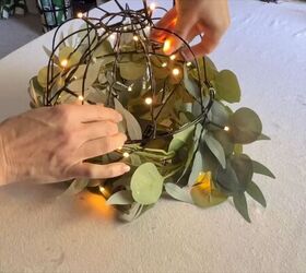 Wrapping fairy lights around pumpkin basket