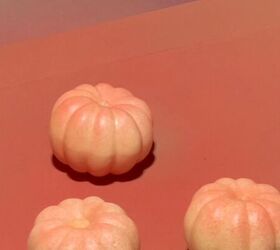 Spraying pumpkins with coral paint