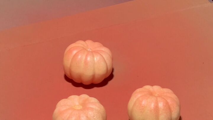 Spraying pumpkins with coral paint