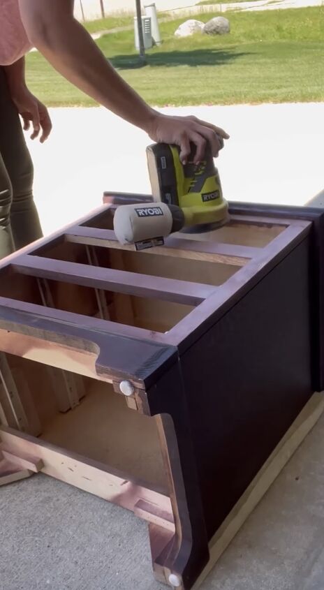 Sanding the surface of the nightstand