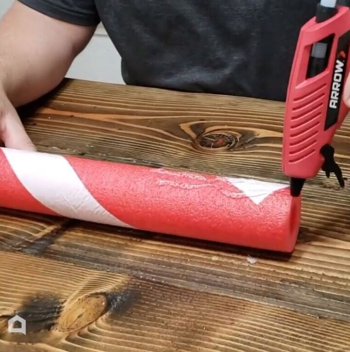 Applying hot glue to the end of the noodle