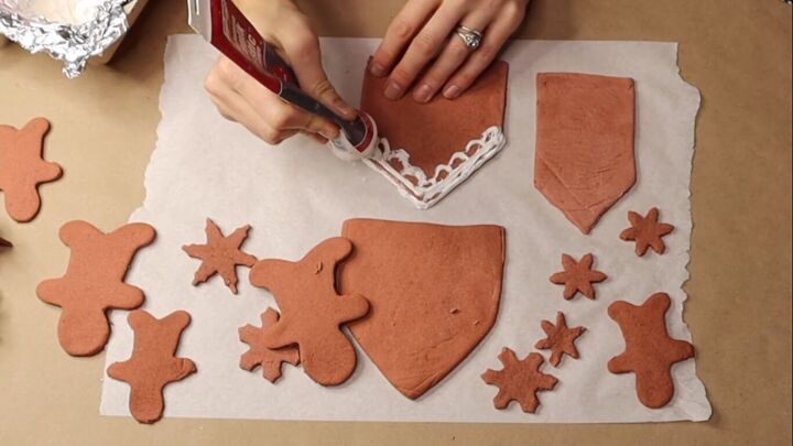 Using caulk to add frosting detail to the gingerbread houses
