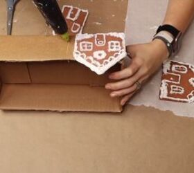 Gluing the gingerbread houses to the box