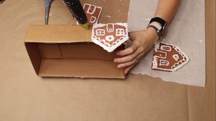 Gluing the gingerbread houses to the box