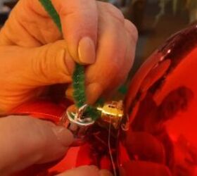 Threading a pipe cleaner through the ornaments