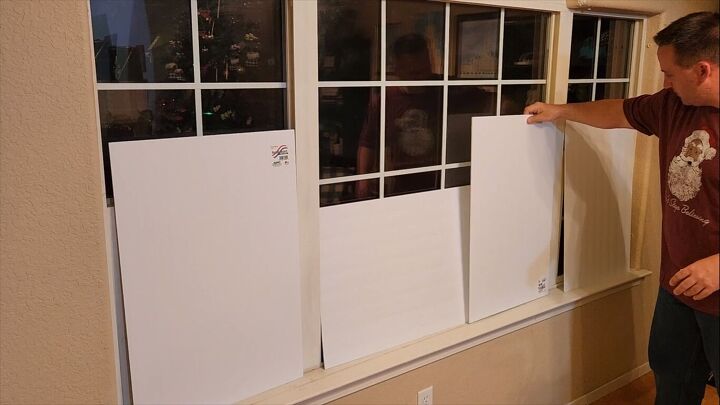 Placing the foam board pieces against the windows