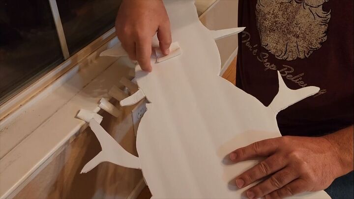 Attaching loops of tape to the shapes