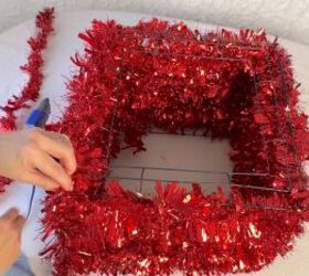 Covering the top of the gift box with tinsel garland
