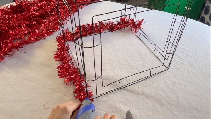 Wrapping tinsel garland around the box