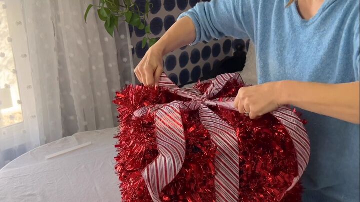 Tying the bow tails to the gift box