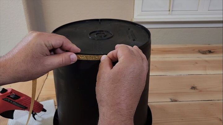 Attaching gold trim to the top of the helmet