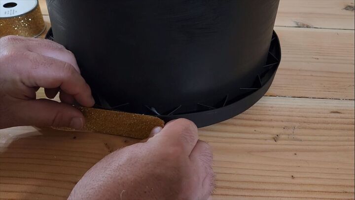 Attaching gold trim to the bottom of the helmet