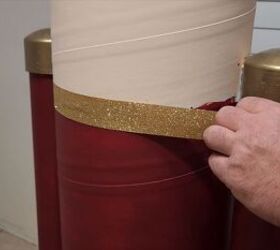 Gluing gold trim to cover the paint lines