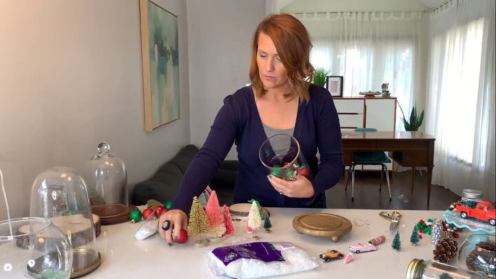 Filling the glass cloche with ornaments