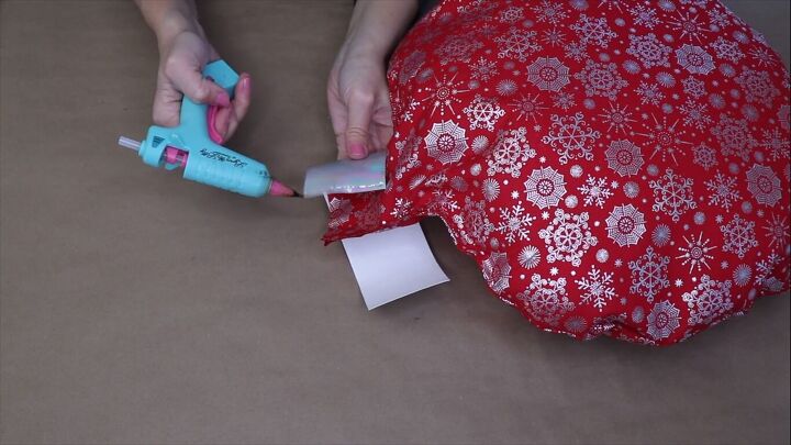 Applying hot glue to the ribbon