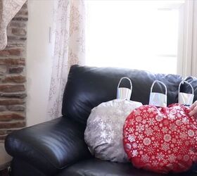 Placing the DIY ornament pillows on the sofa